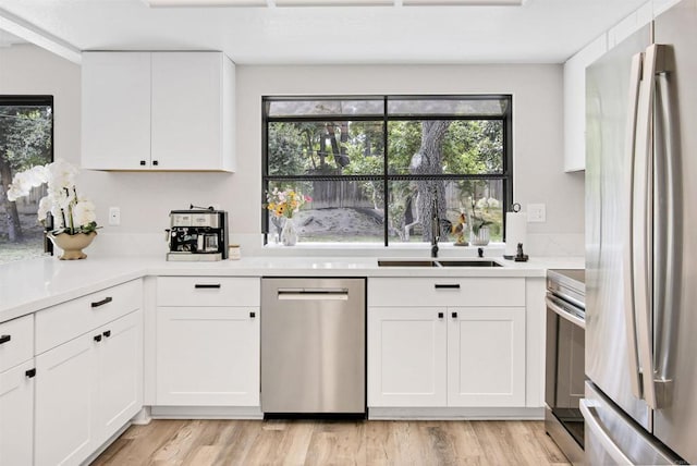 834 Cole Ranch Rd, Encinitas, CA 92024 - kitchen featuring appliances with stainless steel finishes, healthy amount of natural light, white cabinets, and light countertops