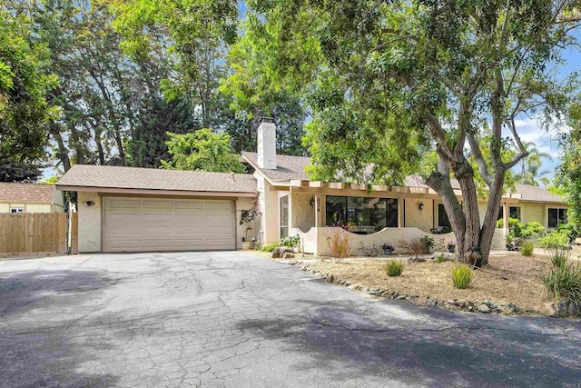 834 Cole Ranch Rd, Encinitas, CA 92024 - single story home with asphalt driveway, stucco siding, a chimney, and an attached garage