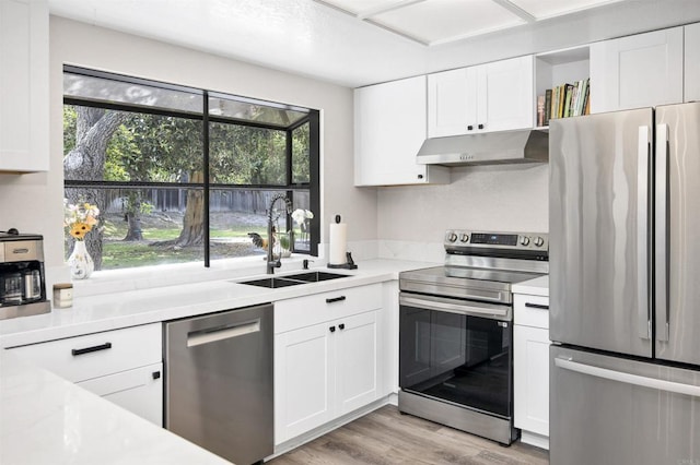 834 Cole Ranch Rd, Encinitas, CA 92024 - kitchen with stainless steel appliances, under cabinet range hood, light countertops, white cabinets, and healthy amount of natural light