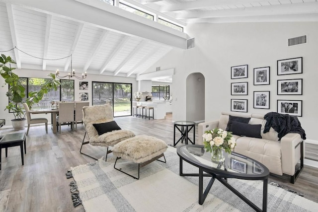834 Cole Ranch Rd, Encinitas, CA 92024 - living area with arched walkways, wood finished floors, a chandelier, high vaulted ceiling, and a wooden ceiling with exposed beams