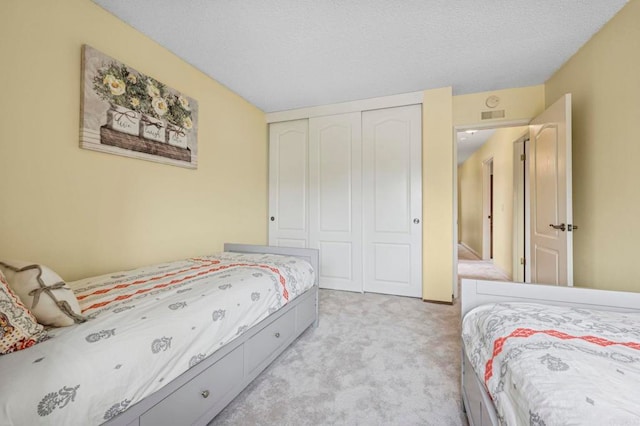3551 Starboard Cir, Oceanside, CA 92054 - bedroom with light carpet, a closet, and a textured ceiling