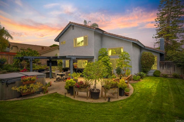 3551 Starboard Cir, Oceanside, CA 92054 - back of property at dusk featuring a hot tub, a pergola, stucco siding, and a patio