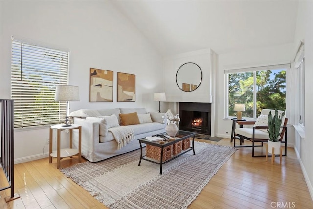 4440 Eagle Peak Rd Unit A, Concord, CA 94521 - living area featuring high vaulted ceiling, light wood finished floors, and a fireplace with flush hearth