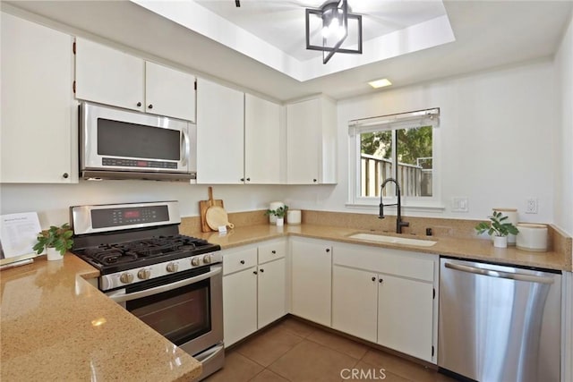 4440 Eagle Peak Rd Unit A, Concord, CA 94521 - kitchen featuring stainless steel appliances, white cabinets, tile patterned flooring, light stone countertops, and a tray ceiling