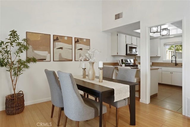 4440 Eagle Peak Rd Unit A, Concord, CA 94521 - dining area with light wood-style floors and a towering ceiling