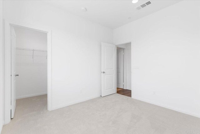 320 El Cajon Blvd, El Cajon, CA 92020 - unfurnished bedroom with light carpet, a walk in closet, and a closet
