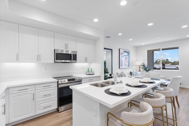 320 El Cajon Blvd, El Cajon, CA 92020 - kitchen featuring stainless steel appliances, light wood-style floors, white cabinetry, and recessed lighting