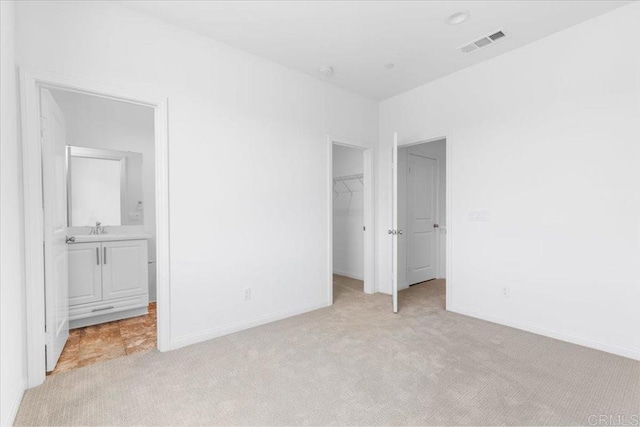 320 El Cajon Blvd, El Cajon, CA 92020 - unfurnished bedroom featuring light carpet, a walk in closet, a closet, and ensuite bathroom