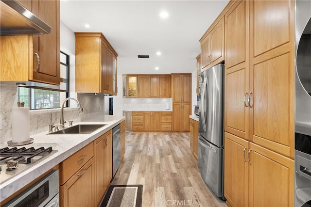 3654 4th Ave, La Crescenta, CA 91214 - kitchen featuring appliances with stainless steel finishes, ventilation hood, light wood-style flooring, tasteful backsplash, and light countertops