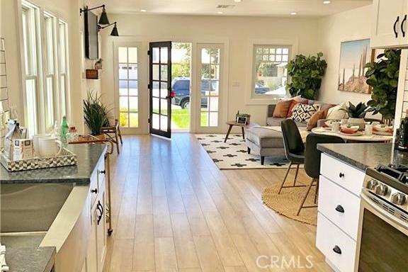 341 W Whiting Ave W, Fullerton, CA 92832 - interior space with light wood-style floors, white cabinets, french doors, gas stove, and open floor plan