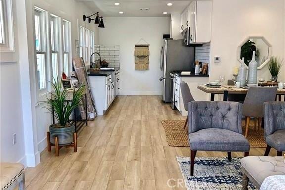 341 W Whiting Ave W, Fullerton, CA 92832 - kitchen featuring dark countertops, white cabinetry, light wood-type flooring, tasteful backsplash, and recessed lighting