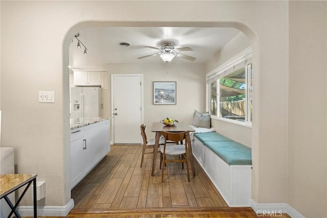 1558 Filbert Ave, Chico, CA 95926 - dining space featuring arched walkways, wood finished floors, and a ceiling fan