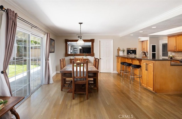 18921 Silver Maple Way N, Tustin, CA 92705 - dining room with light wood-type flooring, ornamental molding, and recessed lighting