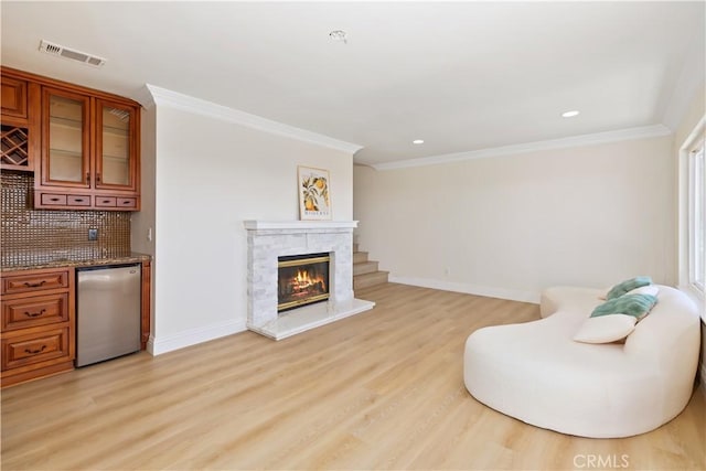 15429 Turquoise Cir N, Chino Hills, CA 91709 - living area featuring light wood-style floors, ornamental molding, recessed lighting, and a stone fireplace