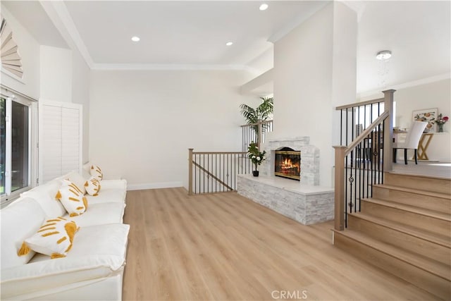 15429 Turquoise Cir N, Chino Hills, CA 91709 - living room with crown molding, light wood-style flooring, a stone fireplace, and recessed lighting