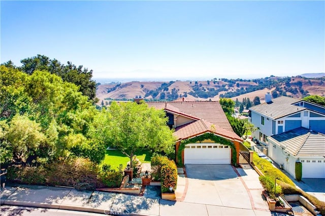 15429 Turquoise Cir N, Chino Hills, CA 91709 - view of front of house featuring concrete driveway, an attached garage, a mountain view, and a tile roof