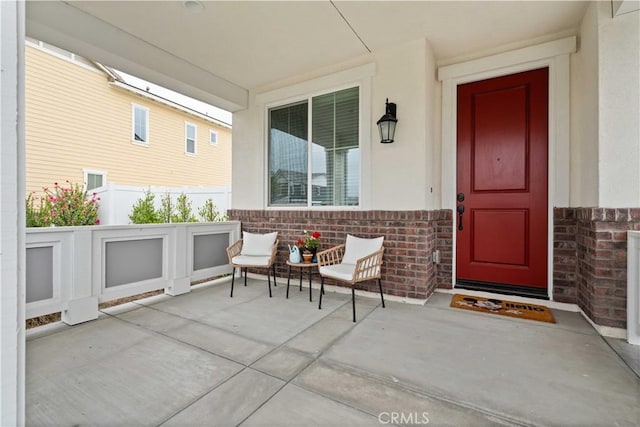 421 Azalea St, Fillmore, CA 93015 - view of exterior entry featuring brick siding, a porch, and stucco siding