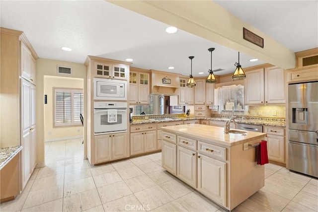 11116 Wayfield Rd, Riverside, CA 92505 - kitchen featuring stainless steel appliances, a kitchen island with sink, tasteful backsplash, glass insert cabinets, and light brown cabinetry