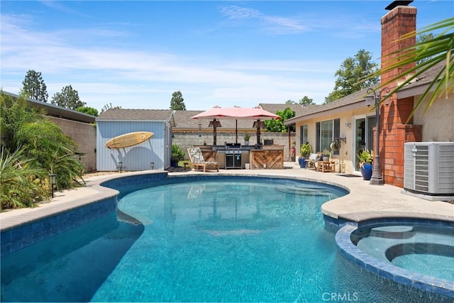 11116 Wayfield Rd, Riverside, CA 92505 - view of pool featuring a storage shed, a pool with connected hot tub, a patio area, and an outdoor kitchen