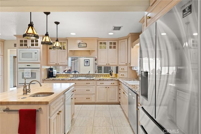 11116 Wayfield Rd, Riverside, CA 92505 - kitchen with appliances with stainless steel finishes, glass insert cabinets, a kitchen island with sink, pendant lighting, and recessed lighting
