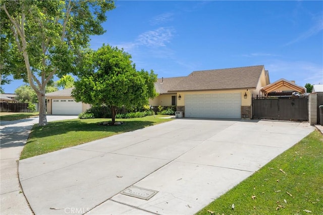 11116 Wayfield Rd, Riverside, CA 92505 - view of front of house featuring an attached garage, driveway, stucco siding, and a gate