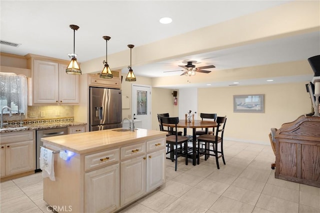 11116 Wayfield Rd, Riverside, CA 92505 - kitchen featuring appliances with stainless steel finishes, backsplash, an island with sink, ceiling fan, and hanging light fixtures