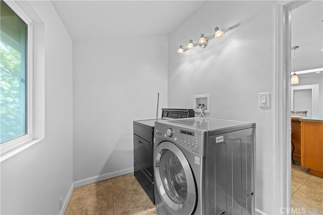 10868 Willowcrest Pl, Studio City, CA 91604 - washroom featuring independent washer and dryer, healthy amount of natural light, and light tile patterned floors