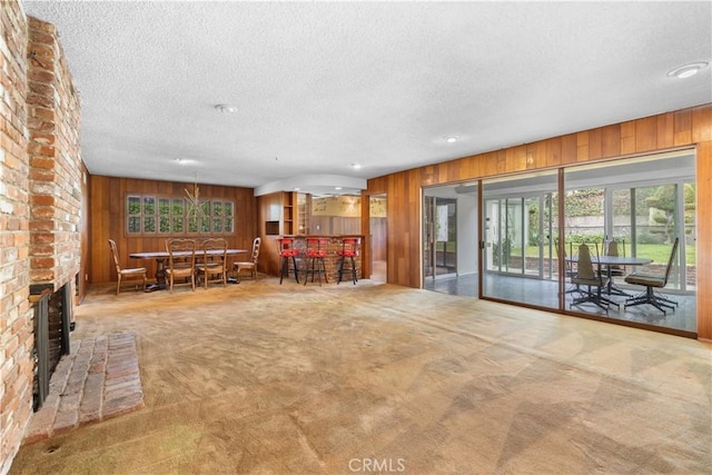 10868 Willowcrest Pl, Studio City, CA 91604 - living area with a textured ceiling, wood walls, carpet flooring, and recessed lighting