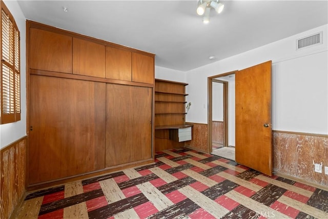 10868 Willowcrest Pl, Studio City, CA 91604 - unfurnished bedroom with a wainscoted wall, wooden walls, and a closet