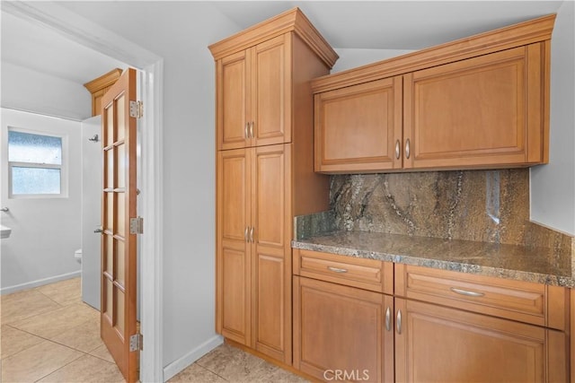10868 Willowcrest Pl, Studio City, CA 91604 - kitchen with backsplash, light tile patterned flooring, and dark stone countertops