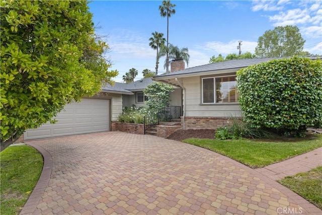 10868 Willowcrest Pl, Studio City, CA 91604 - ranch-style home featuring decorative driveway, a chimney, and an attached garage