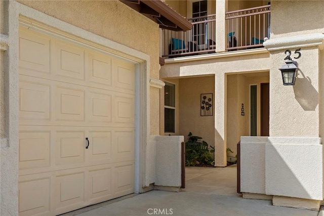25 Vista Palermo, Lake Elsinore, CA 92532 - view of exterior entry featuring stucco siding, a balcony, and a garage
