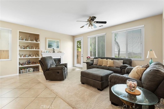 25 Vista Palermo, Lake Elsinore, CA 92532 - tiled living area with a ceiling fan, a fireplace, and built in shelves