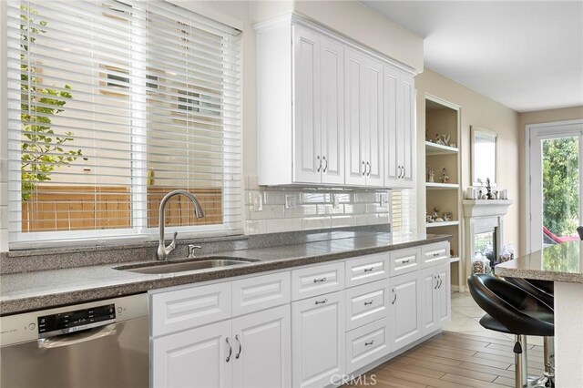 25 Vista Palermo, Lake Elsinore, CA 92532 - kitchen with dishwasher, white cabinets, backsplash, open shelves, and dark stone countertops