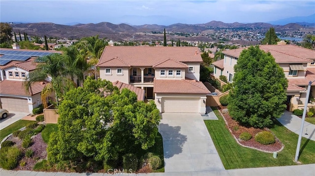 25 Vista Palermo, Lake Elsinore, CA 92532 - mediterranean / spanish-style home featuring a tile roof, stucco siding, concrete driveway, a mountain view, and a residential view