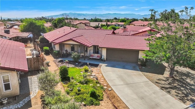 10395 Shahaptain Ave, Hesperia, CA 92345 - view of front of house with a garage, driveway, a residential view, a tiled roof, and a mountain view