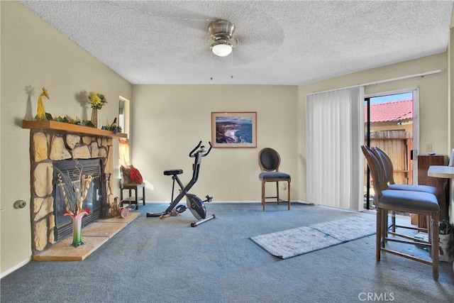 10395 Shahaptain Ave, Hesperia, CA 92345 - exercise area with carpet, ceiling fan, a fireplace, and a textured ceiling
