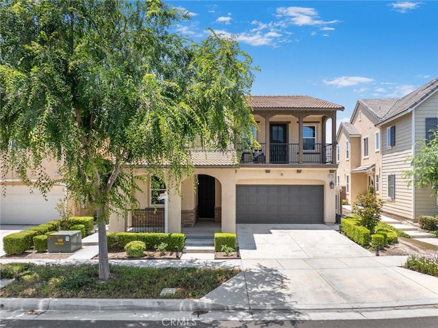 16138 Solitude Ave, Chino, CA 91708 - mediterranean / spanish-style house with a balcony, stucco siding, driveway, a tile roof, and an attached garage