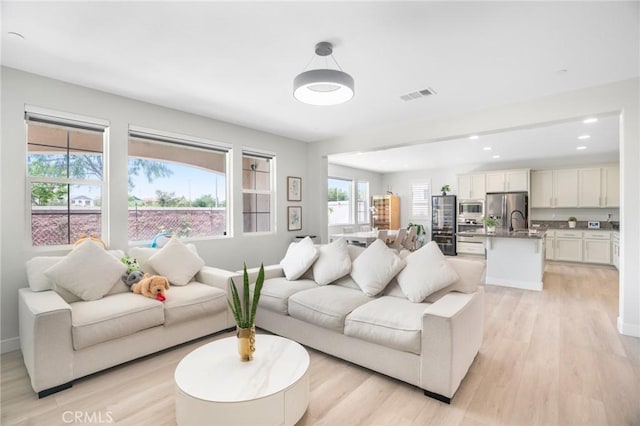 16138 Solitude Ave, Chino, CA 91708 - living area with light wood finished floors and recessed lighting