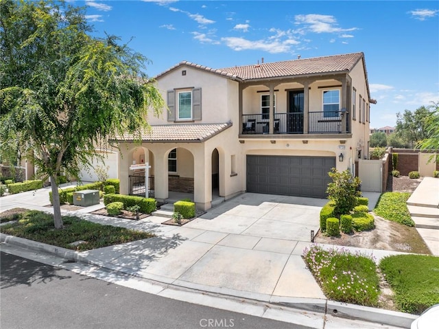 16138 Solitude Ave, Chino, CA 91708 - mediterranean / spanish house with stucco siding, a tile roof, a porch, and an attached garage
