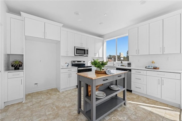 94191/2 N Sepulveda Blvd Unit 1, North Hills, CA 91343 - kitchen with stainless steel appliances, tasteful backsplash, light countertops, and white cabinetry