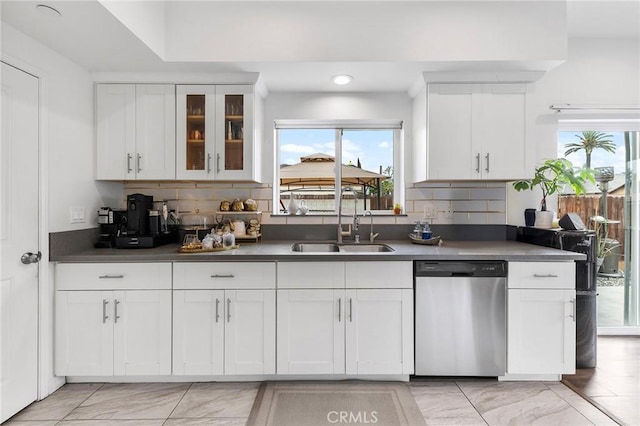 418 N Dalton Ave, Azusa, CA 91702 - kitchen featuring stainless steel dishwasher, white cabinets, decorative backsplash, light marble finish floors, and glass insert cabinets