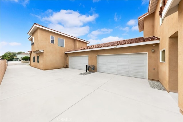418 N Dalton Ave, Azusa, CA 91702 - view of side of property featuring driveway, stucco siding, a tile roof, and a garage