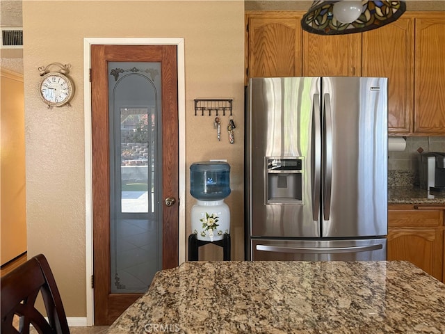 4474 Juanita Ct, Chino, CA 91710 - kitchen featuring stainless steel refrigerator with ice dispenser, dark stone countertops, backsplash, and a textured wall