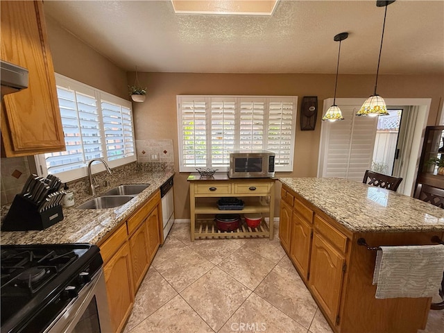 4474 Juanita Ct, Chino, CA 91710 - kitchen featuring stainless steel appliances, healthy amount of natural light, brown cabinetry, and a textured ceiling