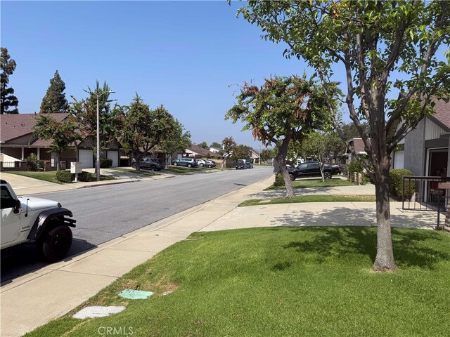 4474 Juanita Ct, Chino, CA 91710 - view of asphalt road with sidewalks, a residential view, and curbs