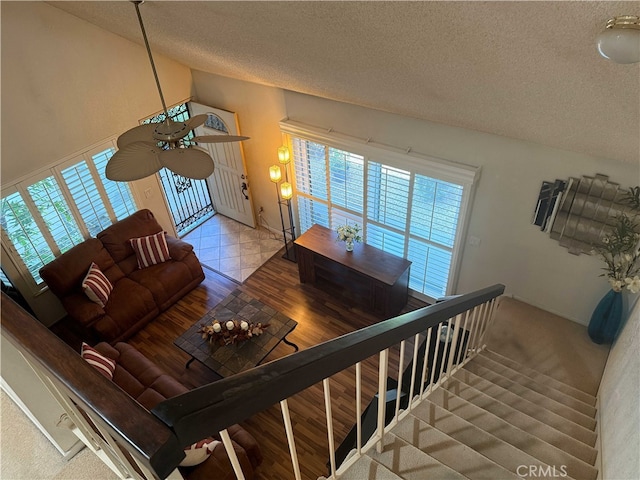 4474 Juanita Ct, Chino, CA 91710 - living room featuring a textured ceiling, vaulted ceiling, and wood finished floors