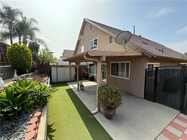 4474 Juanita Ct, Chino, CA 91710 - rear view of house featuring stucco siding, a patio area, a fenced backyard, and a shed