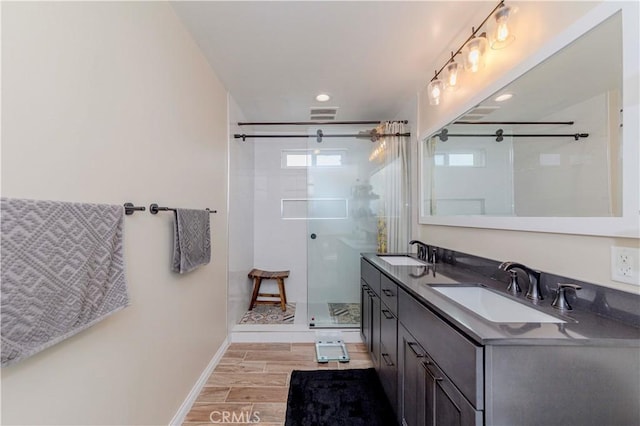 5276 Willow Wood Rd, Rolling Hills Estates, CA 90274 - bathroom with double vanity, wood finished floors, a shower stall, and recessed lighting