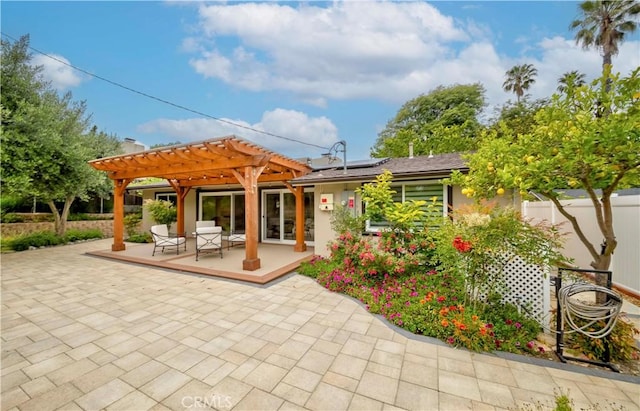 5276 Willow Wood Rd, Rolling Hills Estates, CA 90274 - back of house with a pergola, roof mounted solar panels, and a patio